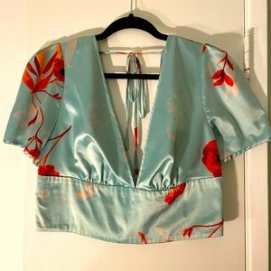 Blue Bebe crop top. Size 16. Silky with red flower details.